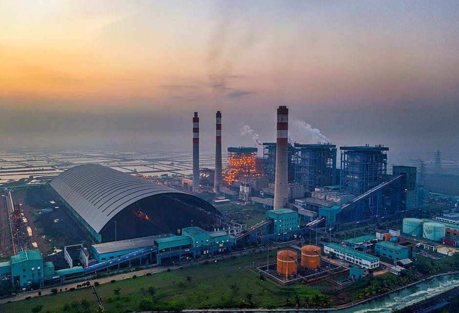 Aerial view of a large industrial power plant at sunset