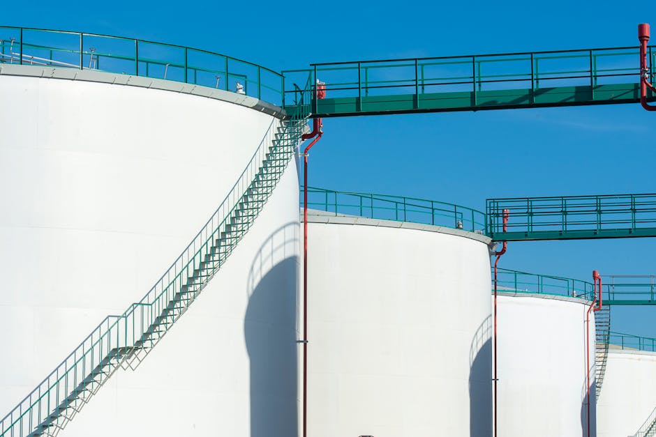 Large industrial storage tanks with elevated walkway at a remote oilfield water handling site